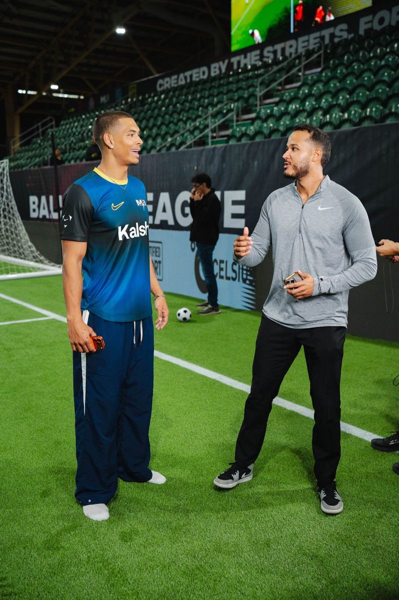 Talking with a player on the Baller League pitch
